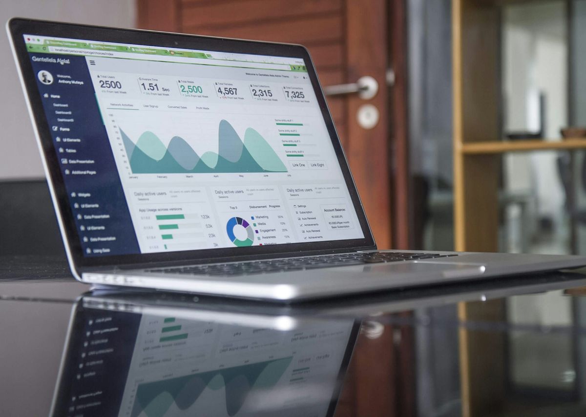 A laptop on a desk showing an analytics dashboard
