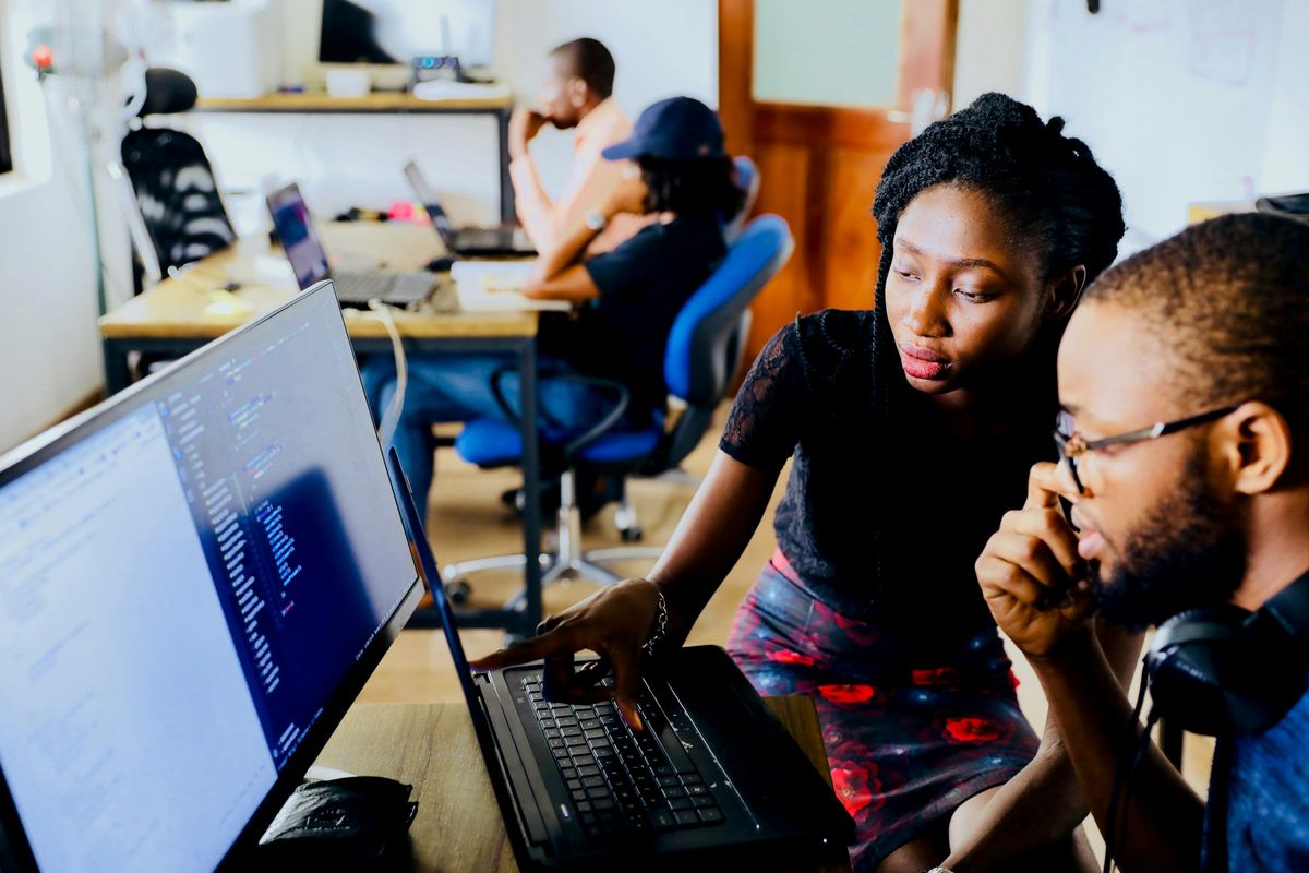 Two consultants working through a system together at a computer