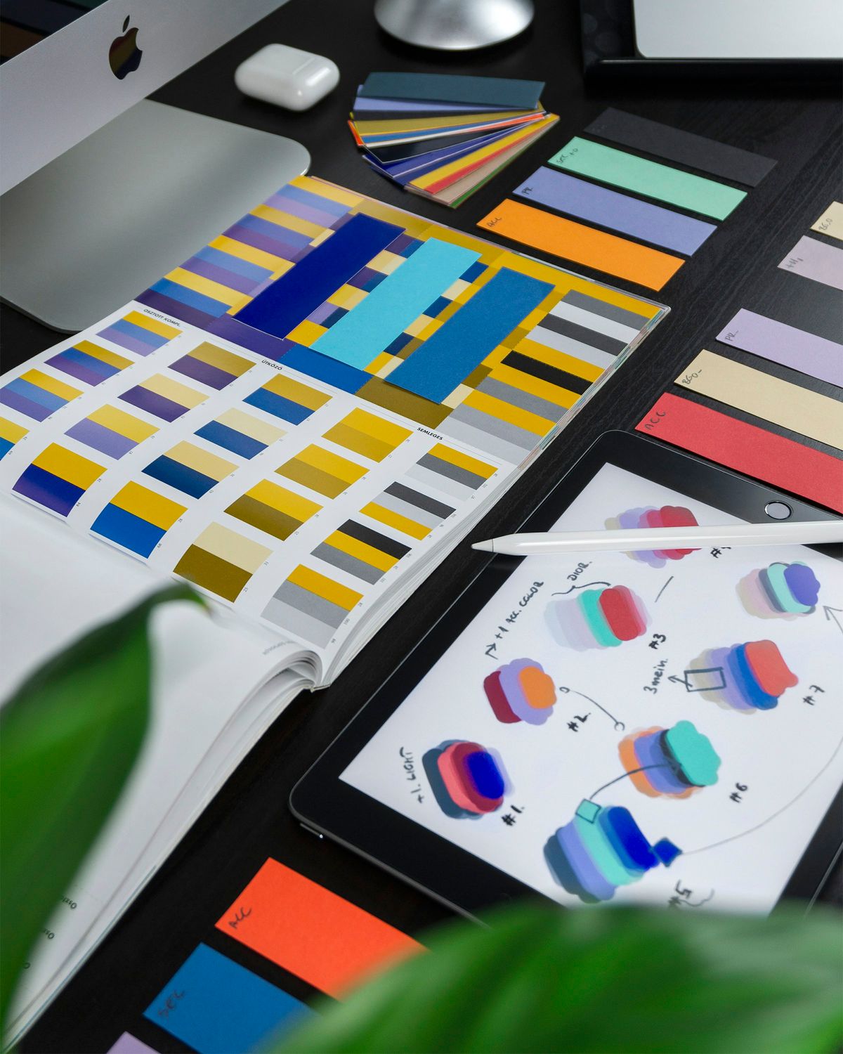 Colour swatches and design samples spread out on a desk