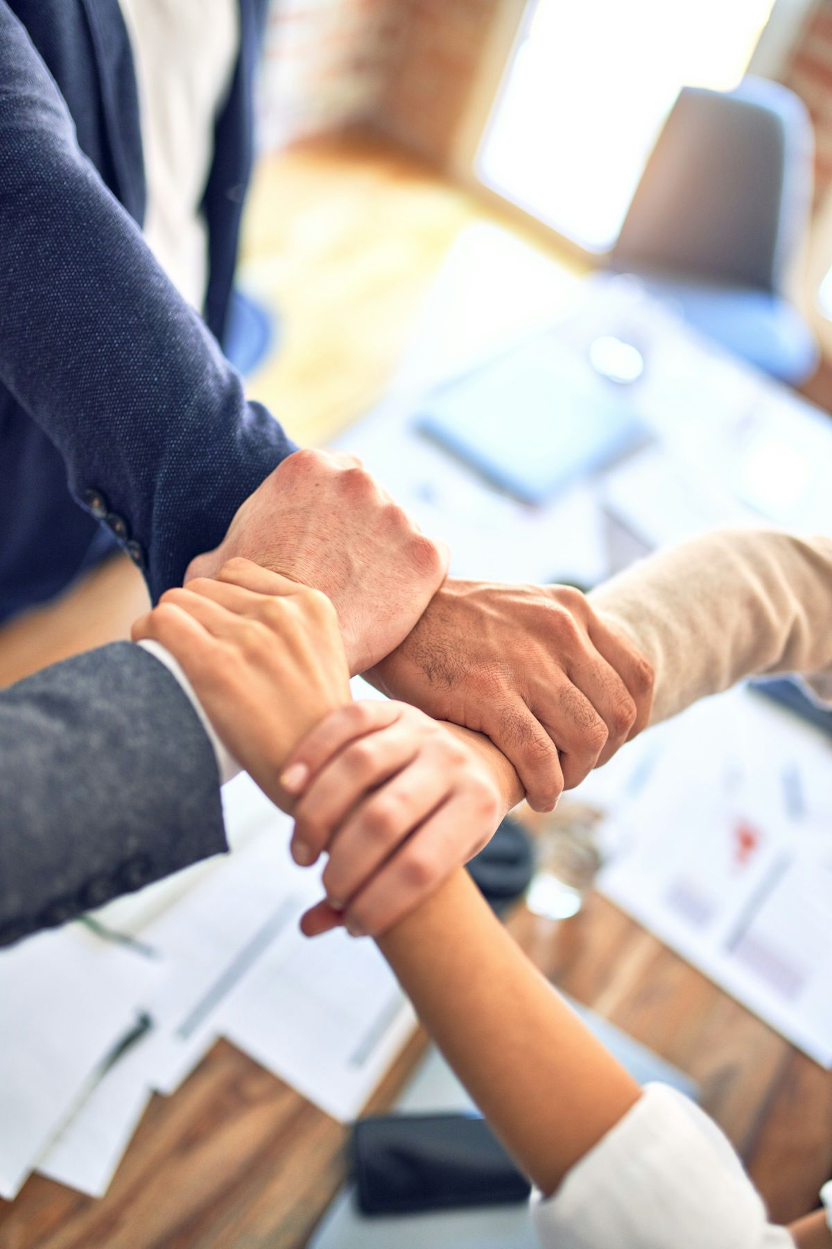 A team stacking their hands together